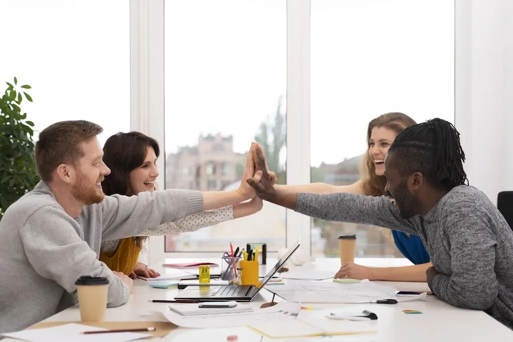 Diverse culture employees high fiving