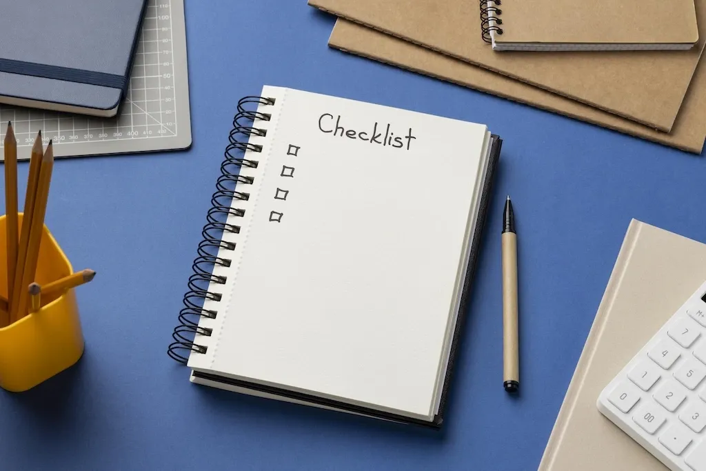Top view of checklist written on notebook