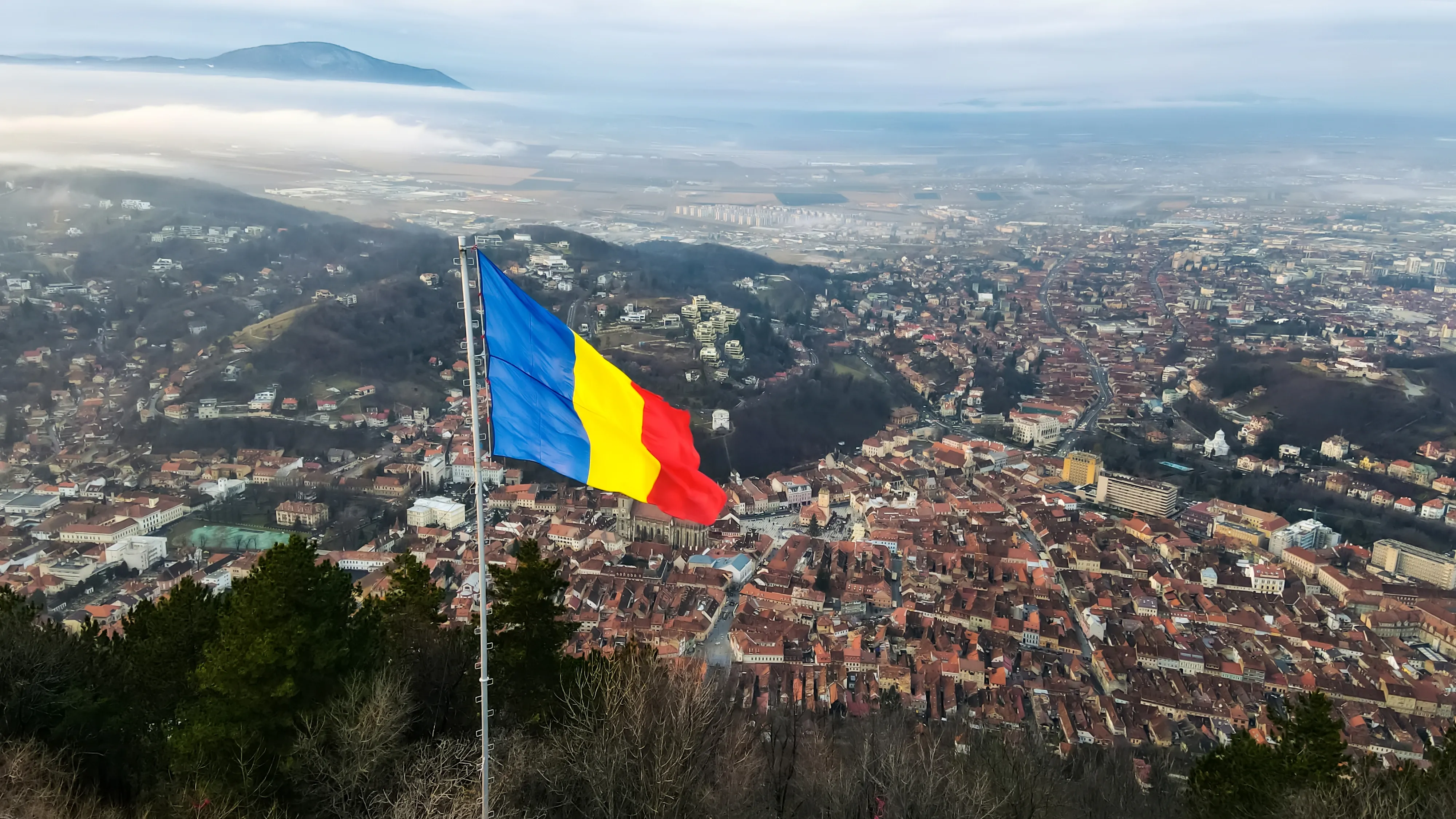 Top shot of Romania flag above the city