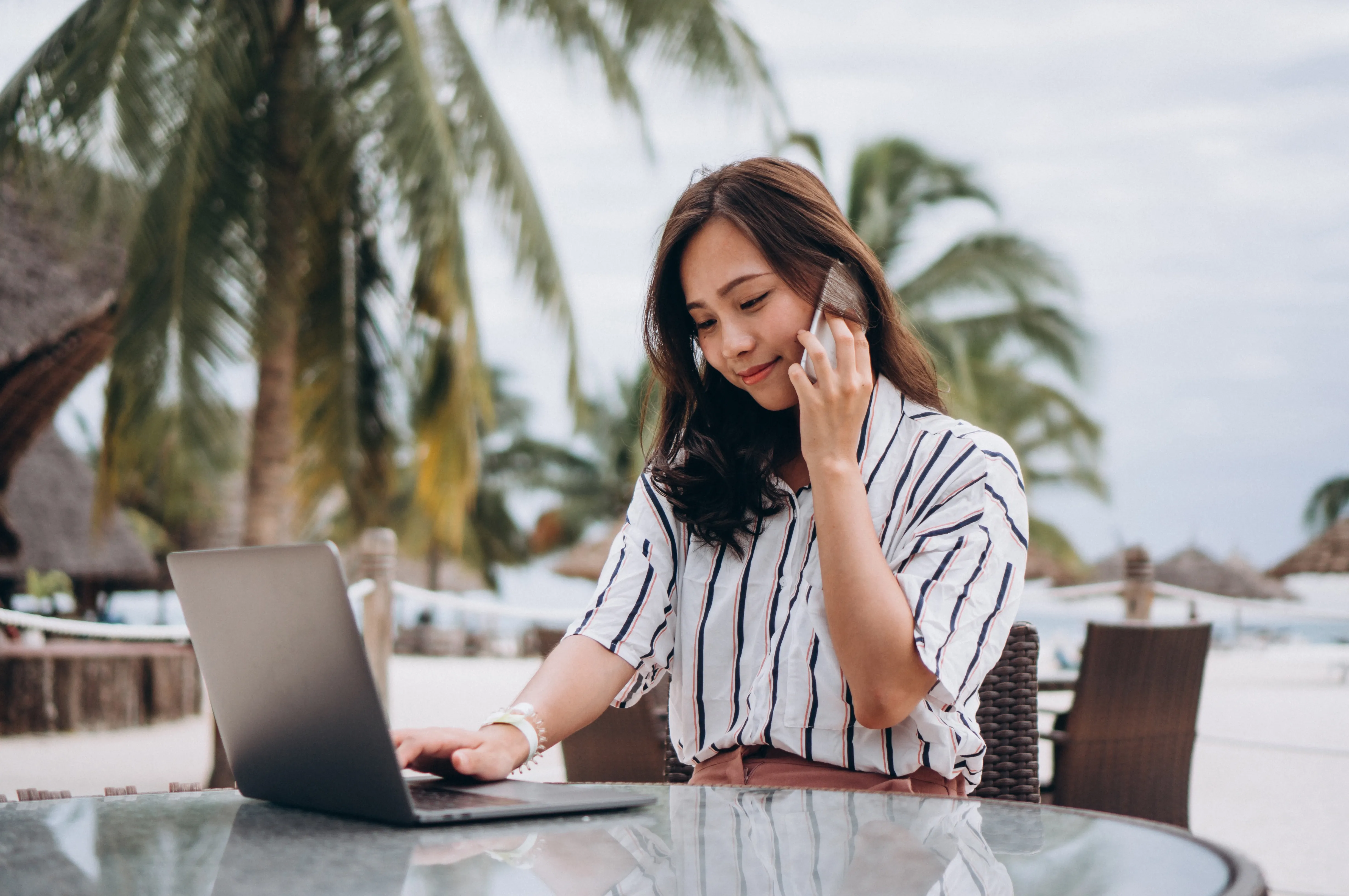 asian-woman-working-laptop-vacation.webp