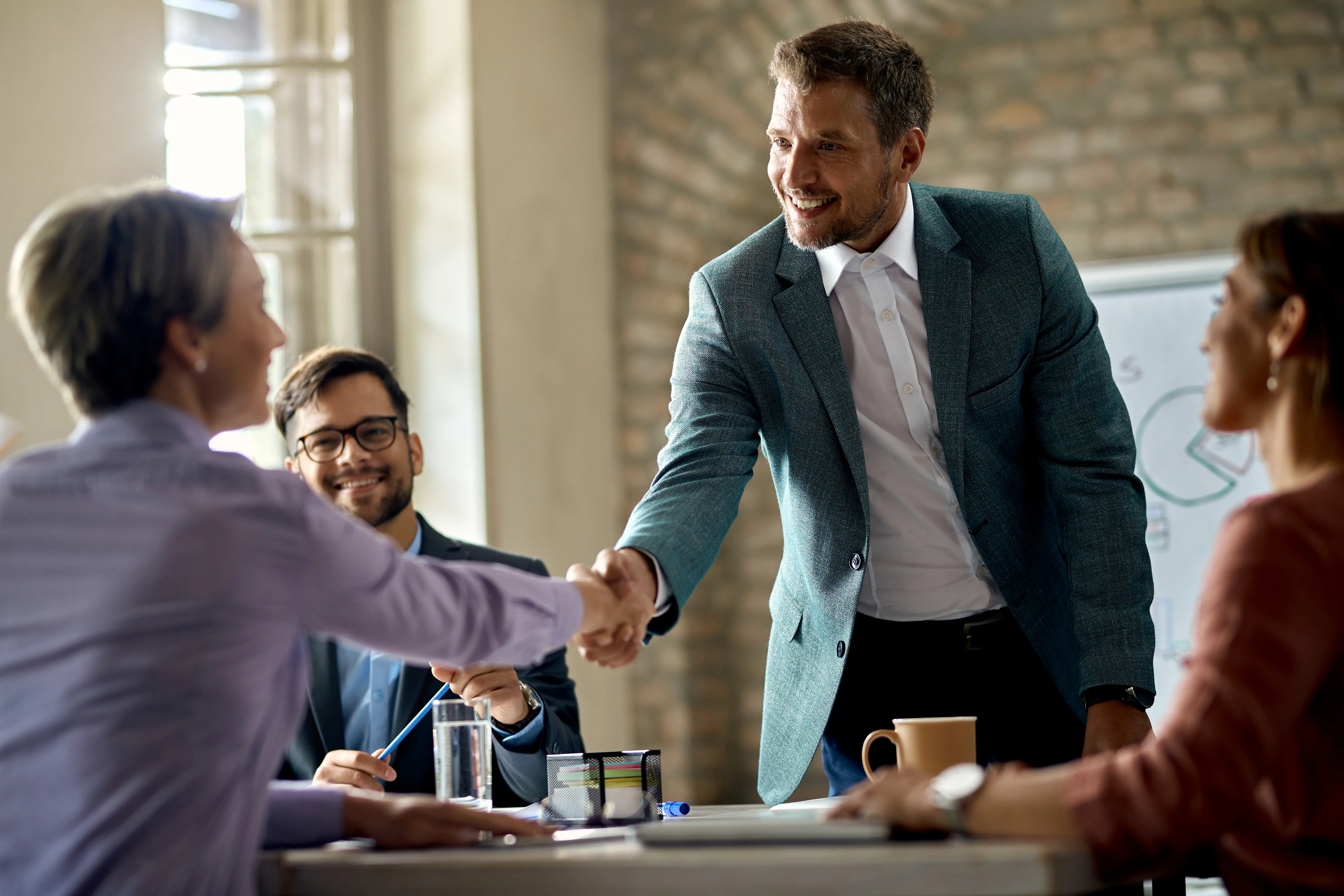 business-coworkers-shaking-hands-meeting-office-focus-is-businessman.webp