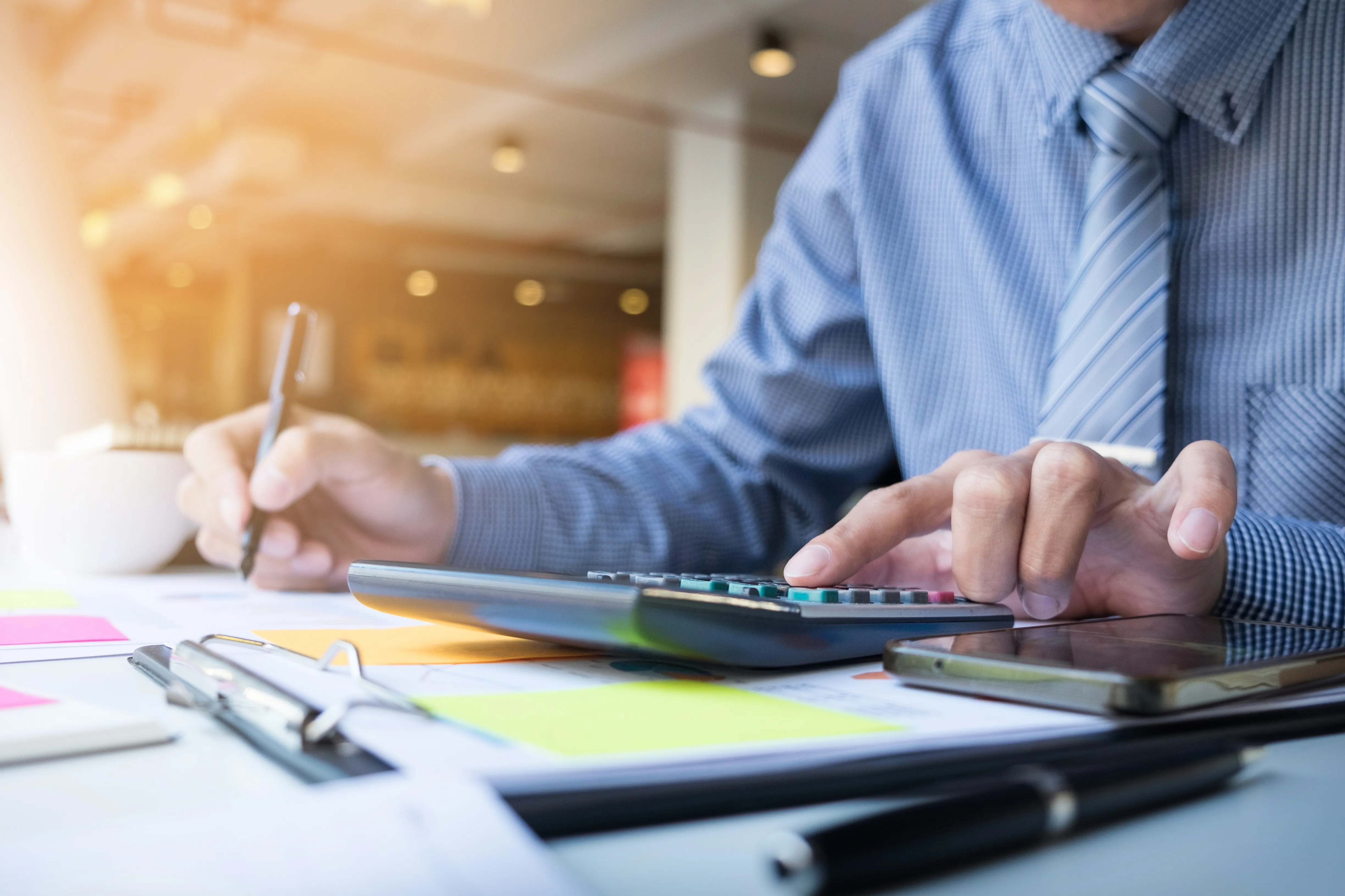 business-finance-man-calculating-budget-numbers-invoices-financial-adviser-working.webp