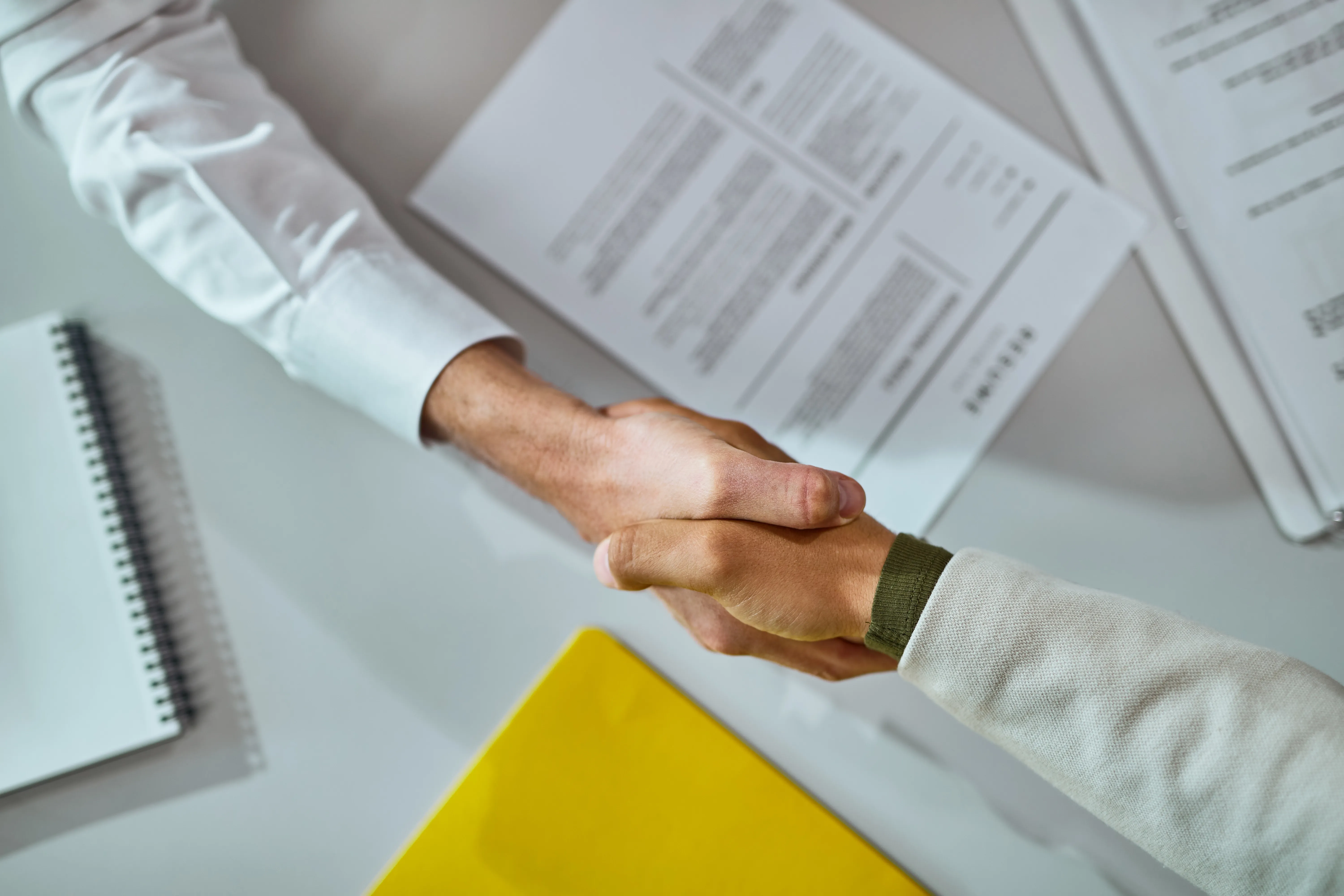 closeup-businessmen-shaking-hands-after-successful-agreement.webp