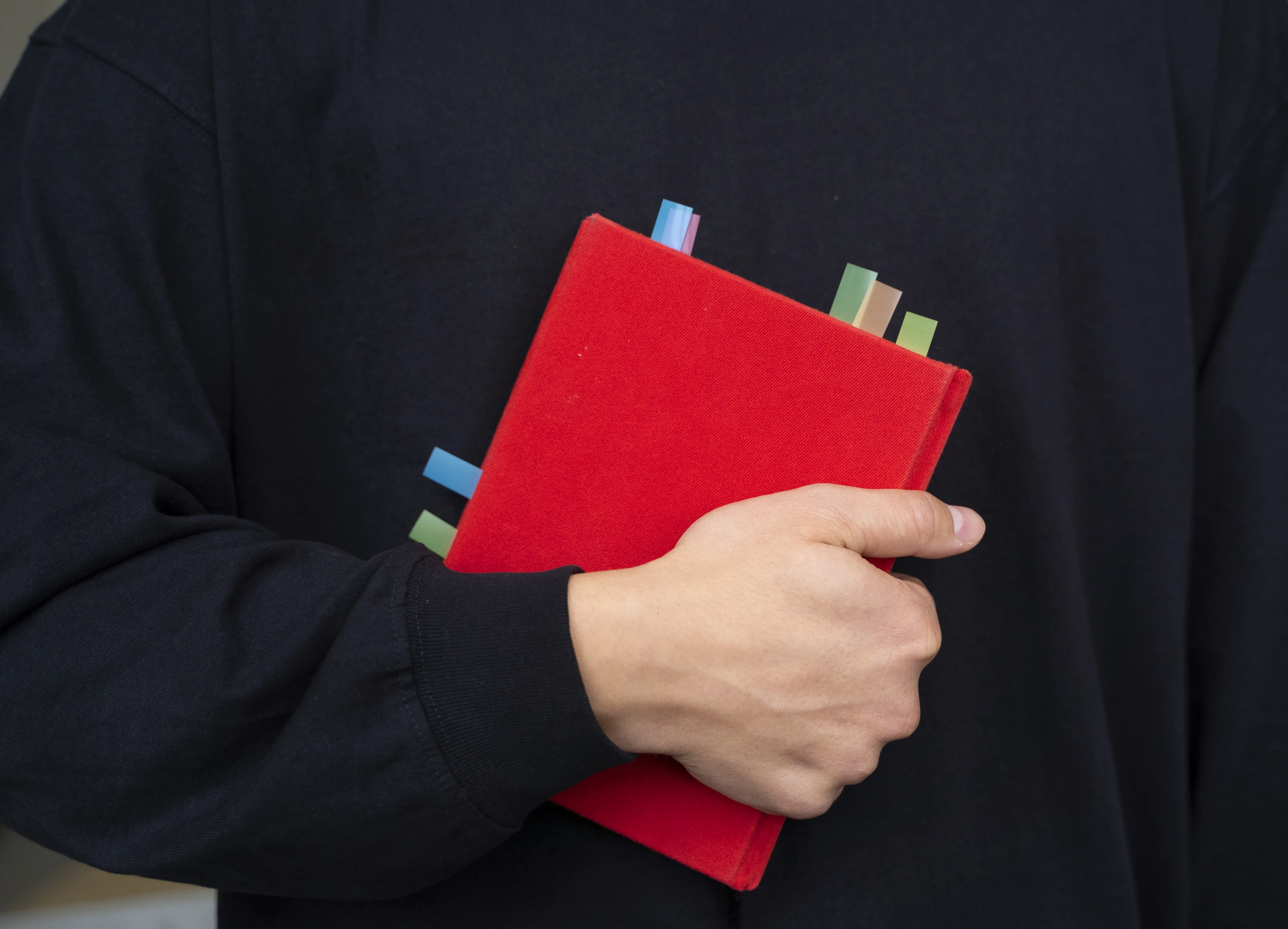 front-view-model-holding-book.webp