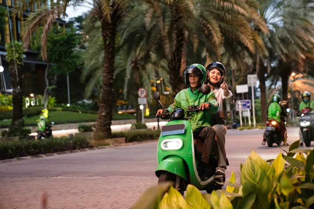 A girl with a man riding on a bike taxi