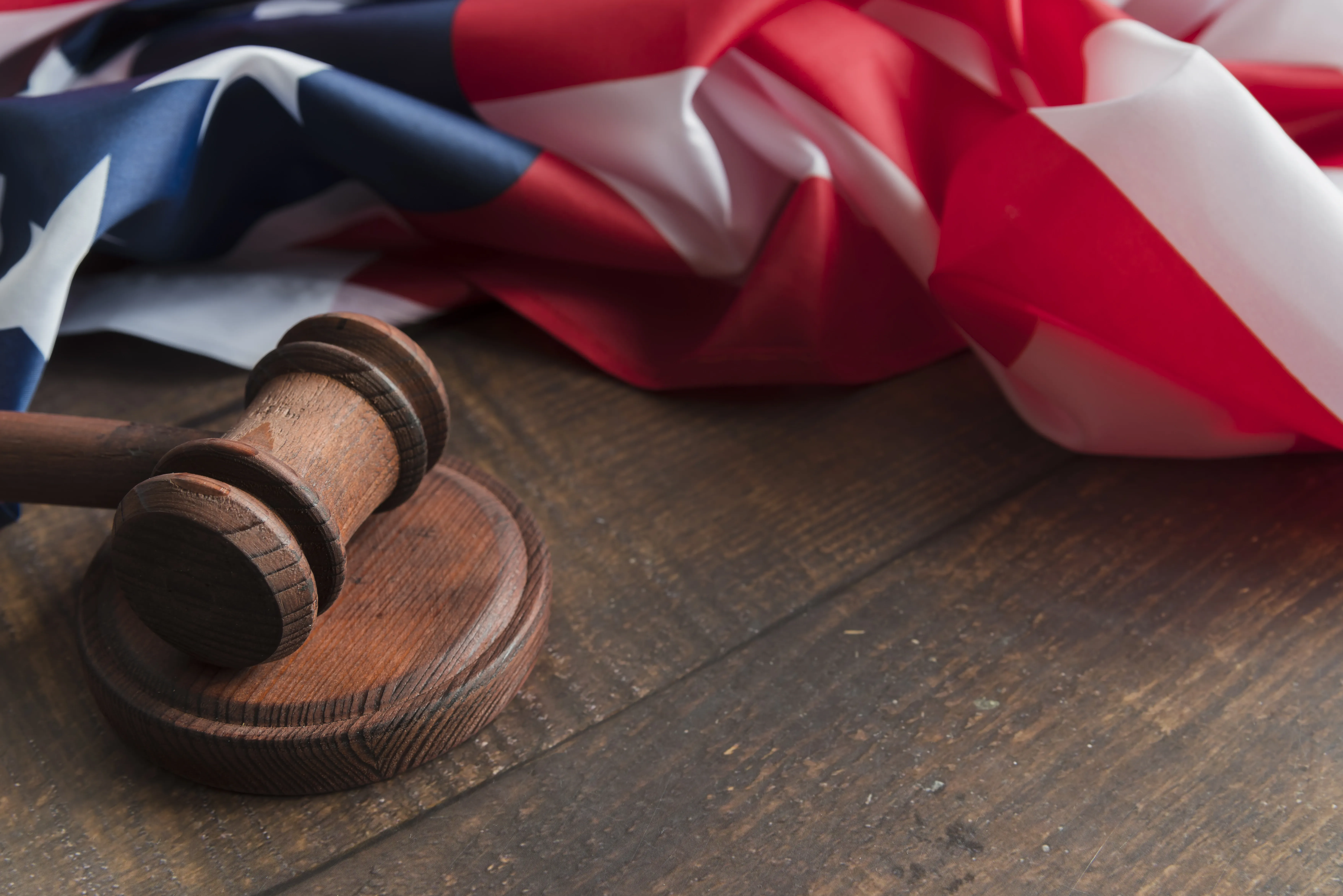 judge-s-gavel-with-flag.webp