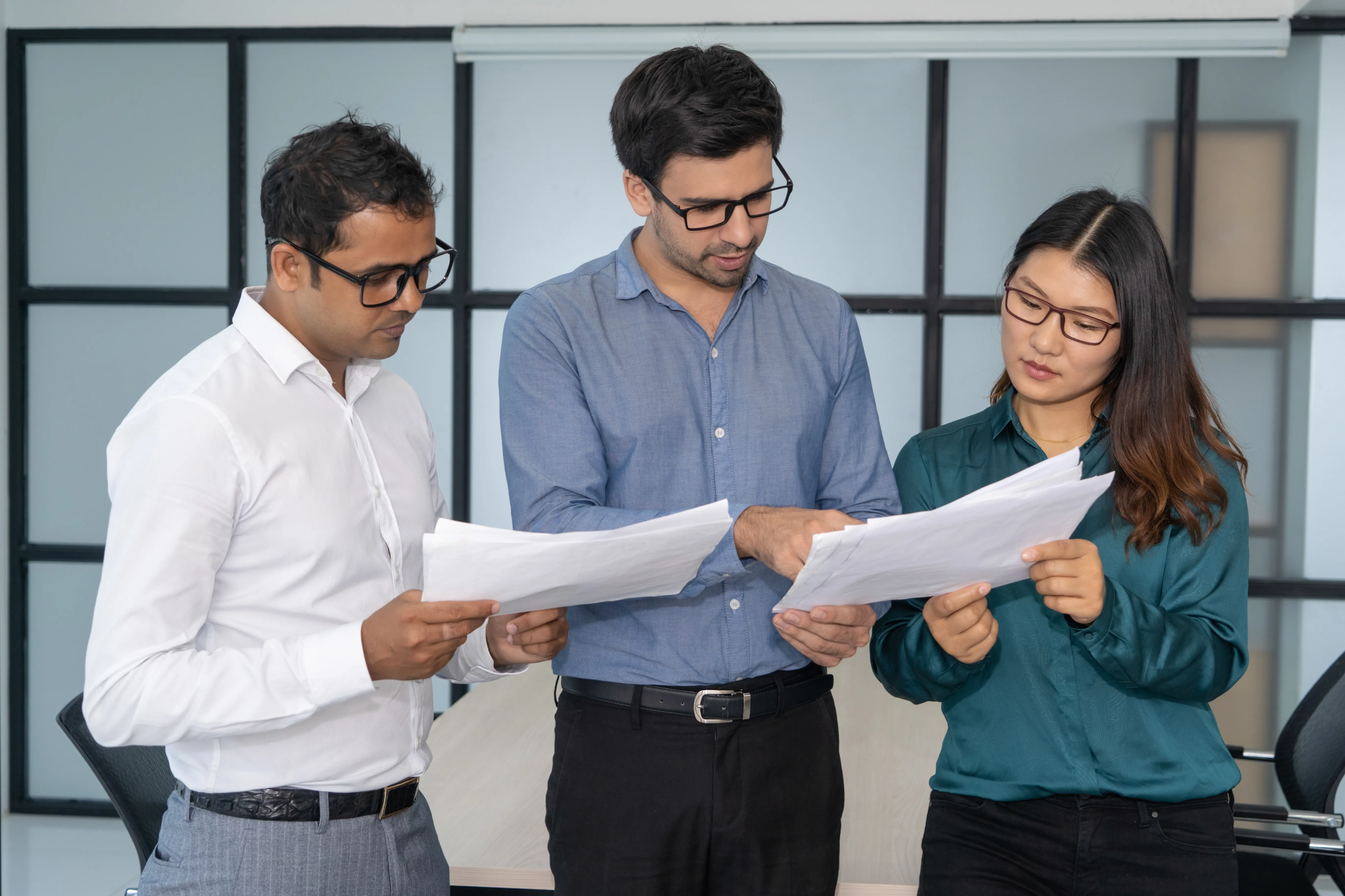 multiethnic-business-team-analyzing-financial-reports.webp
