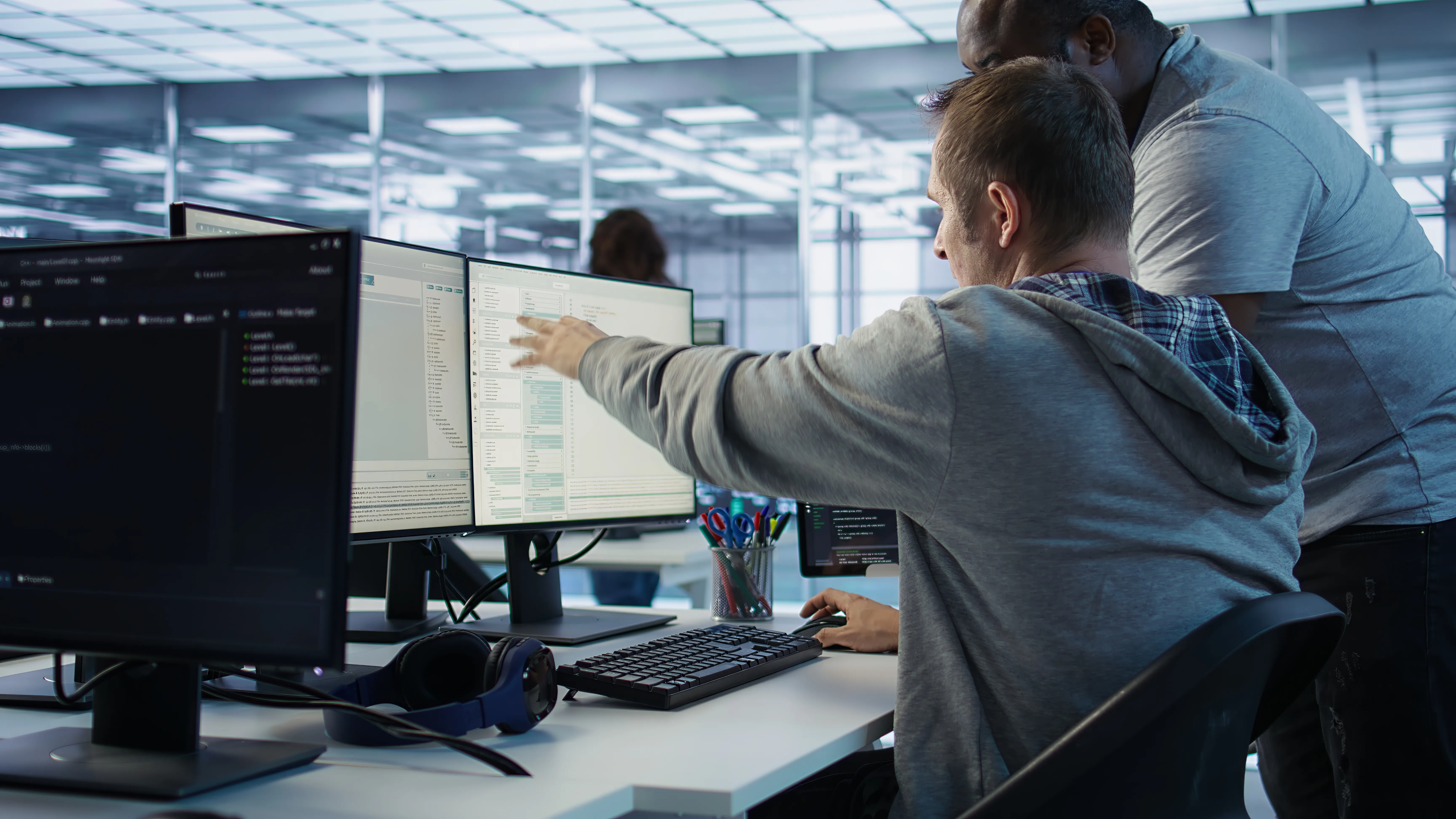 programmer-requesting-help-from-manager-while-working-computer-data-center.webp